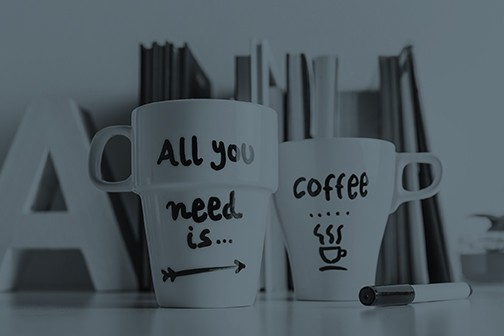 Two coffee cups with the words all you need is coffee